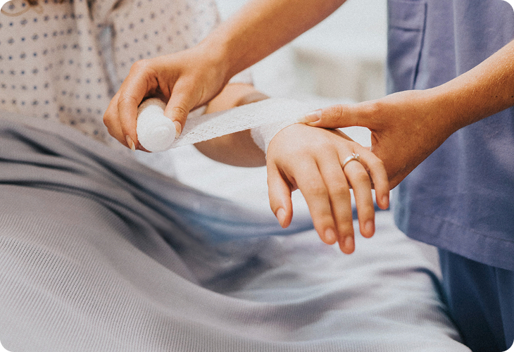 Clinician examining a patient's injured wrist and hand