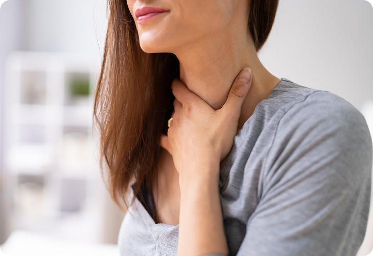 Clinician examining a patient's throat and tonsils